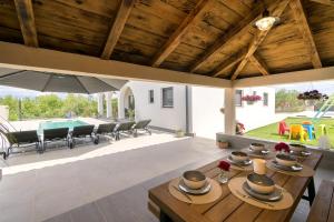 a living room with a table with hats on it at Villa Olivarum in Stankovci