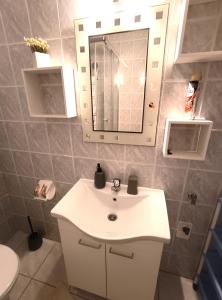 a bathroom with a white sink and a mirror at Apartments Vuleta in Pag +152 photos