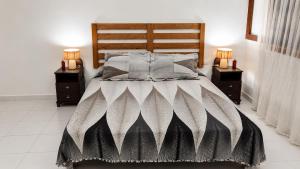 a bedroom with a large bed with two night stands at Plage al amin eden in Fnidek