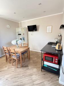 a kitchen and dining room with a table and chairs at Dom na wsi in Chmielno