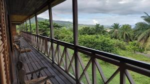 a balcony with a view of the jungle at Roça Monte Forte in Neves