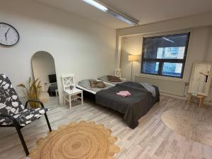 a bedroom with a bed and a clock on the wall at Office to sleep in heard of Lohja in Lohja