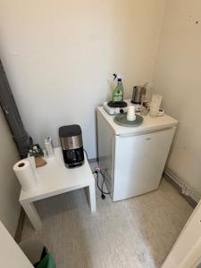 a small room with a coffee maker on a table at Office to sleep in heard of Lohja in Lohja