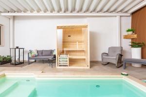 a living room with a swimming pool and a house at Pasitea Luxury Suite by BarbarHouse in Squinzano