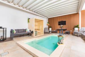 a swimming pool in a living room with a couch and a tv at Pasitea Luxury Suite by BarbarHouse in Squinzano