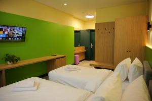 a hotel room with two beds and a green wall at BVS Hotel in Ukrayinka +2 photos