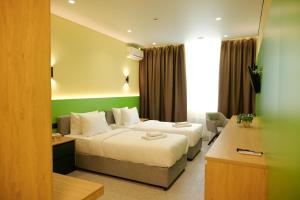 a hotel room with two beds and a couch at BVS Hotel in Ukrayinka