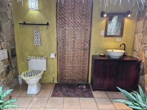 a bathroom with a toilet and a sink at San Simian Lodge in La Laguna +115 photos