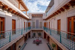 an empty balcony of a building with a table at Asal Boutique Hotel in Bukhara