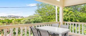 a porch with a white table and chairs on a balcony at Wayaca Mini Resort in Willemstad