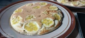 a pizza with bananas and peanut butter on a plate at Lombok Rice Terracce Glamping in Tetebatu +55 photos