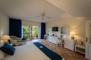 a bedroom with a large bed and a living room at BlueBay Banús in Marbella