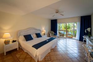 a bedroom with a large bed with blue pillows at BlueBay Banús in Marbella +47 photos