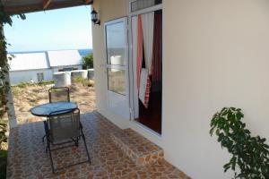a chair sitting on a patio next to a window at Chez Mimi in Rodrigues Island
