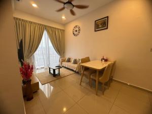 a living room with a table and a couch at Piccadilly Greentown Ipoh by Jun - City Views in Ipoh
