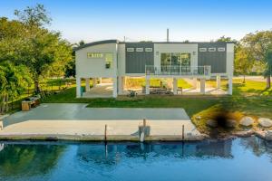 a house with a dock in front of a body of water at BP07FLR Big Pine Key Dreams in Big Pine Key