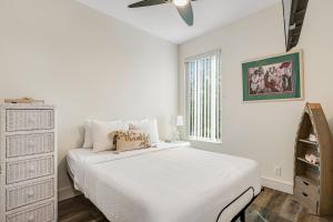 a white bedroom with a bed and a dresser at BP07FLR Big Pine Key Dreams in Big Pine Key +26 photos