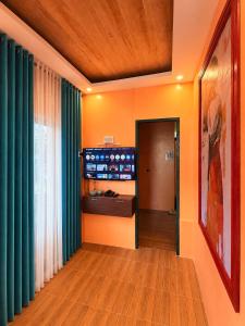 a hallway with green drapes and a room with a hallway at Casa Paco Siargao in Catagnan