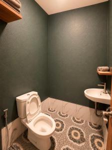 a bathroom with a toilet and a sink at Casa Paco Siargao in Catagnan +17 photos