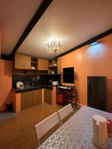 a kitchen with a table and chairs in a room at Casa Paco Siargao in Catagnan