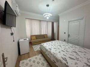 a bedroom with a bed and a couch in it at Mürefte Suite in Tekirdağ