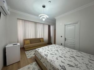 a bedroom with a bed and a couch in it at Mürefte Suite in Tekirdağ