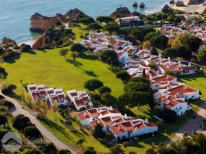 an aerial view of a village next to the ocean at Aldeamento Turistico da Prainha in Alvor