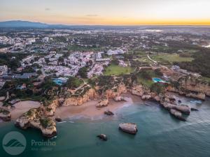an aerial view of a beach with rocks in the water at Aldeamento Turistico da Prainha in Alvor