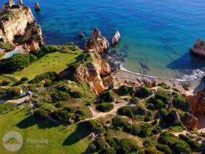 an aerial view of a rocky island in the ocean at Aldeamento Turistico da Prainha in Alvor