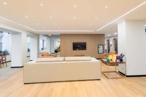 a large living room with a couch and a tv at Hotel Évora by Rede Sagres in Florianópolis +2 photos