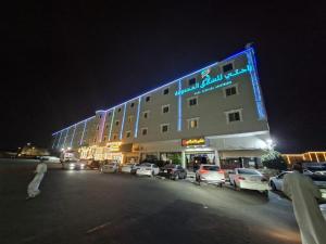 a large building with a sign on it at night at راحتي ستار للشقق المخدومة in Ukaz