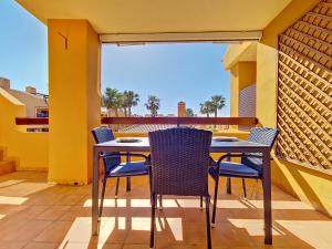 a patio with a table and chairs on a balcony at Albatros Playa 3 - 3409 in Mar de Cristal