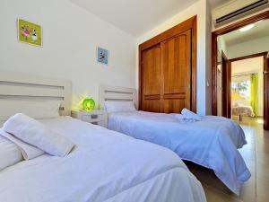 a bedroom with two beds and a door at Albatros Playa 3 - 3409 in Mar de Cristal +33 photos