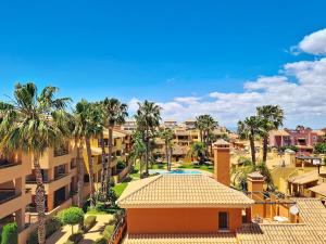 a view of a resort with palm trees and a building at Albatros Playa 3 - 3409 in Mar de Cristal