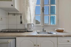 a kitchen with a sink and a window at Yiorgo's Studios in Kalymnos +47 photos