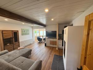 a living room with a couch and a table at Ferienhaus Schmiedweg 10 in Altmünster