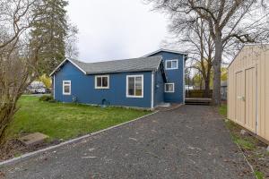 a blue house in a yard with a fence at The Palouse Perch in Moscow