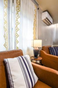 a living room with two chairs and a lamp at The Palouse Perch in Moscow