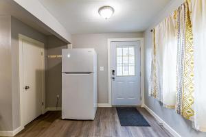 a white refrigerator in a room with a door at The Palouse Perch in Moscow