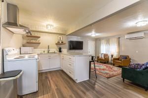a kitchen with white appliances and a living room at The Palouse Perch in Moscow