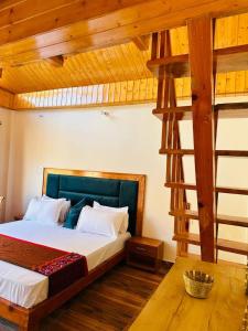 a bedroom with a large bed and a ladder at Above & Beyond - Tirthan in Banjār