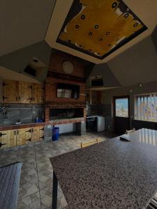 a large kitchen with a table in the middle at Vlasic Odmor - Villa Kraljica in Vlasic