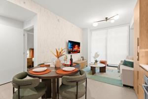 a dining room and living room with a table and chairs at 1Bd Top Location Downtown Miami in Miami