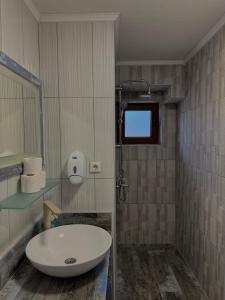 a bathroom with a white sink and a mirror at Vlasic Odmor - Villa Kraljica in Vlasic +47 photos
