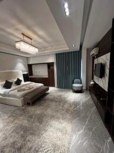 a large bedroom with a bed and a tv at Macdonald Residence in Lagos +54 photos