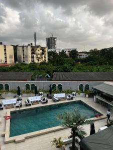 a swimming pool with lounge chairs and a building at Macdonald Residence in Lagos