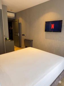 a bedroom with a white bed and a sign on the wall at Peri Boutique Hotel Taksim in Istanbul