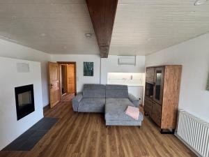 a living room with a couch and a tv at Ferienhaus Schmiedweg 10 in Altmünster