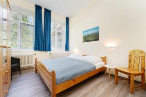 a bedroom with a bed and a desk and a chair at Gut Staberhof Staberwind in Staberdorf