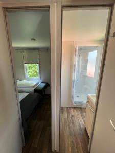 a small room with a bed and a refrigerator at Mobilheim in Laichingen